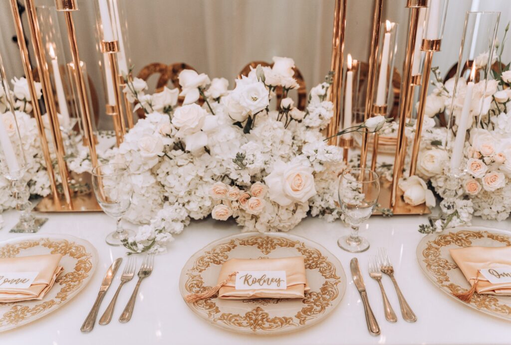 Table setting with ornate decor and floral arrangements at wedding event